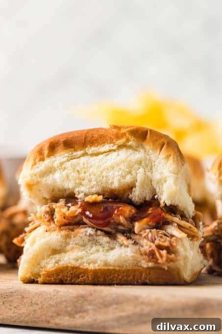 A delicious plate of BBQ Chicken Sliders garnished with fresh parsley.