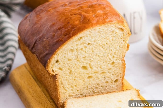 Warm and Fluffy Potato Bread 2 A loaf of easy Potato Bread on a cutting board, ready to be sliced.