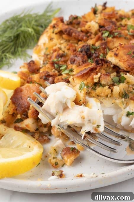 A bite of tilapia cooked in an air fryer on a fork.