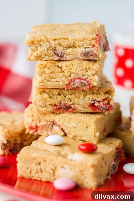 Close-up of M&M Valentine Blondies, showcasing the vibrant red, pink, and white candies.