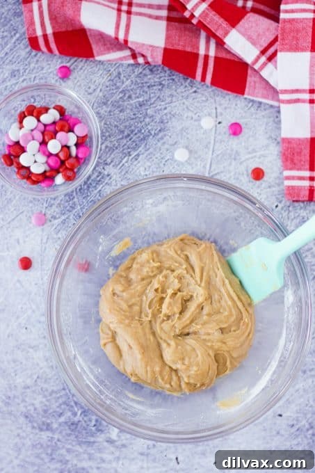 Blondie batter with M&M's mixed in, ready for baking.