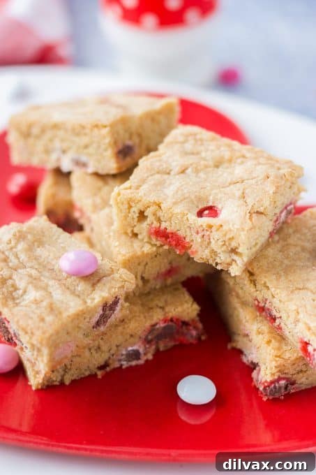Perfectly baked Blondies with red and pink Valentine M&M's on a wire rack.