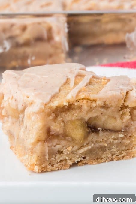 Apple Crumble Bars 3 Stack of freshly baked apple pie bars on a cooling rack.