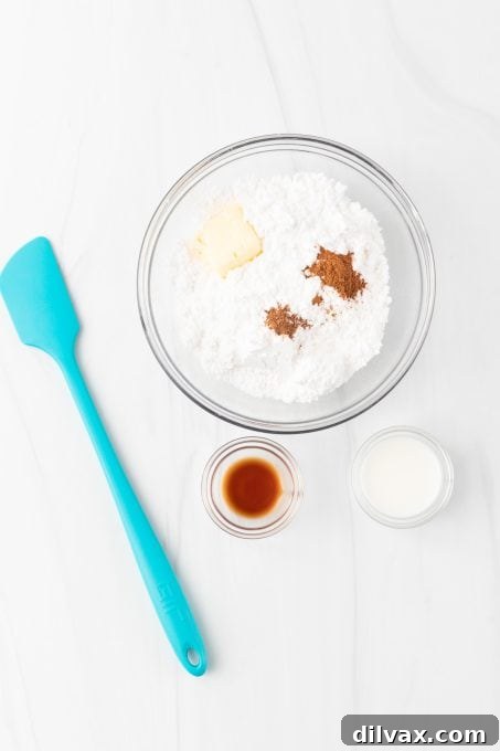Apple Crumble Bars 7 Mixing a spiced powdered sugar glaze in a small bowl.
