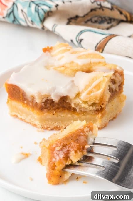 Spiced Pumpkin Squares 11 A pumpkin bar with a bite taken out, showing the spiced filling and crumbly topping.