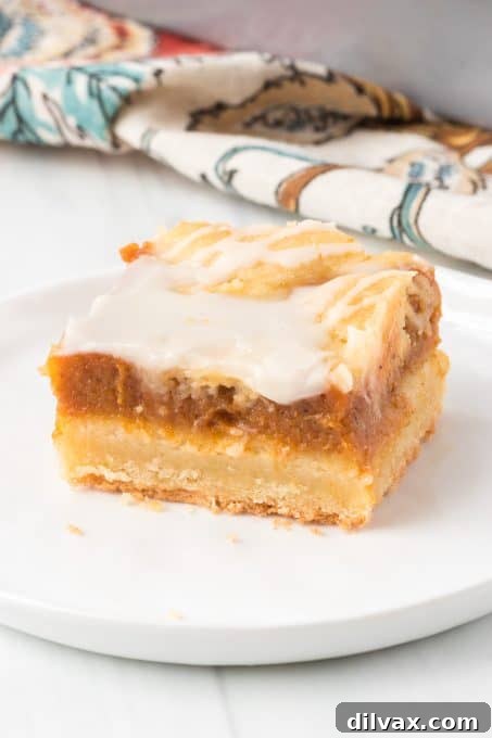 Spiced Pumpkin Squares 9 A slice of pumpkin-filled pie bar with creamy texture.