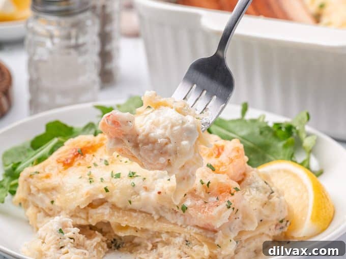 Oceanic Lasagna 11 A fork taking a delicious bite out of the creamy seafood lasagna, showing the layers of pasta, crab, and shrimp.
