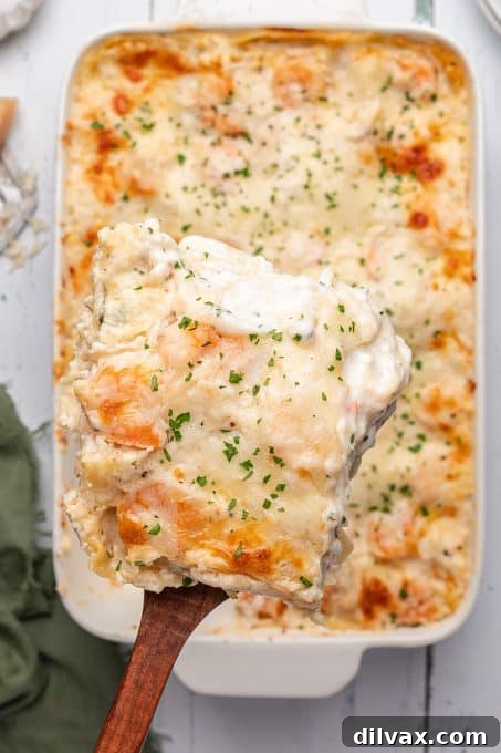 Oceanic Lasagna 9 A serving of homemade lasagna filled with tender crab and shrimp meat, showcasing its rich, creamy layers.