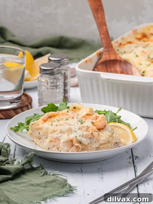 Oceanic Lasagna 10 A close-up of a generous slice of homemade shrimp and crab lasagna on a plate, ready to be enjoyed.