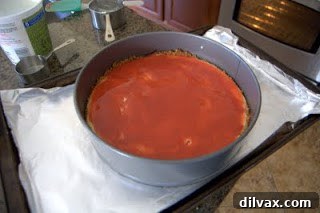 Cheesecake with a layer of strawberry puree and yogurt topping.