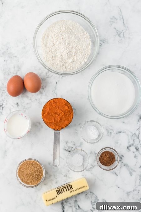 Deliciously Spiced Pumpkin Bread 4 Essential ingredients for homemade pumpkin bread laid out.