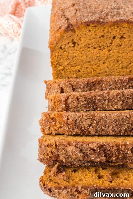 Deliciously Spiced Pumpkin Bread 7 A perfectly baked loaf of pumpkin bread on a wire rack.