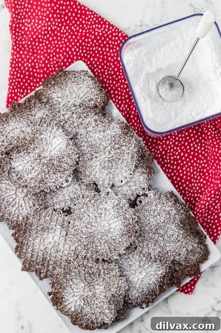 A close-up view of multiple pizzelles made with cocoa, showing off their perfect round shape and detailed patterns.
