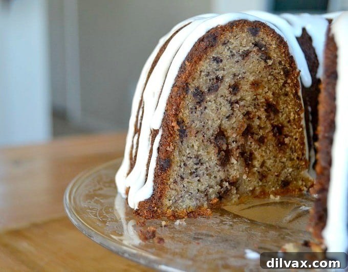 A moist delicious banana bundt cake filled with mini chocolate chips and drizzled with a cream cheese frosting!