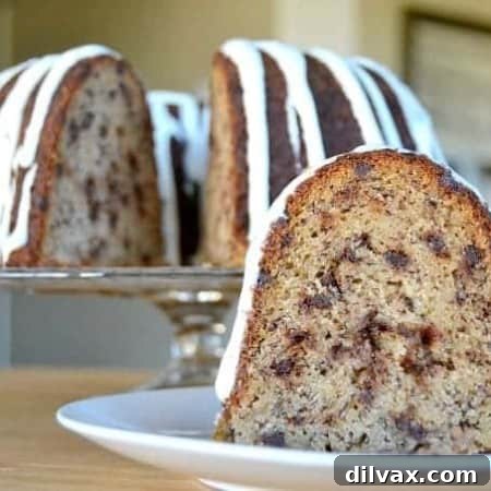 A moist delicious banana bundt cake filled with mini chocolate chips and drizzled with a cream cheese frosting!