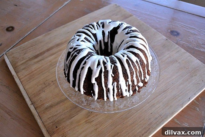 A moist delicious banana bundt cake filled with mini chocolate chips and drizzled with a cream cheese frosting!