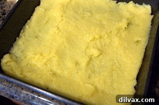 Hearty Tamale Pie 3 Spreading cornmeal crust into a baking pan