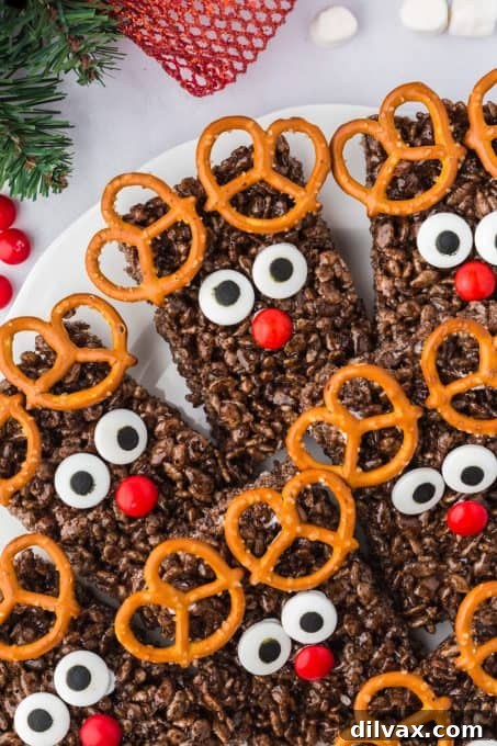 A plate of finished Chocolate Rice Krispie Rudolph Treats with festive background.