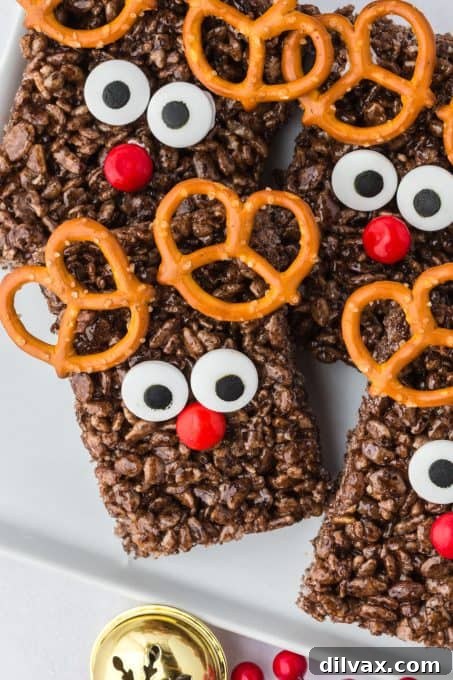 Close up of a Rudolph Rice Krispie Treat, highlighting the details of the candy eyes and red M&M nose.