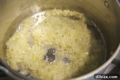 Baked Ravioli Bliss and a Shopping Spree 2 Sautéing onions and garlic in a pan for ravioli sauce