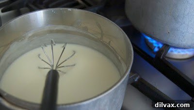 Creamy Baked Rigatoni with Bechamel 3 Creamy Bechamel sauce simmering in a saucepan, ready for assembly.