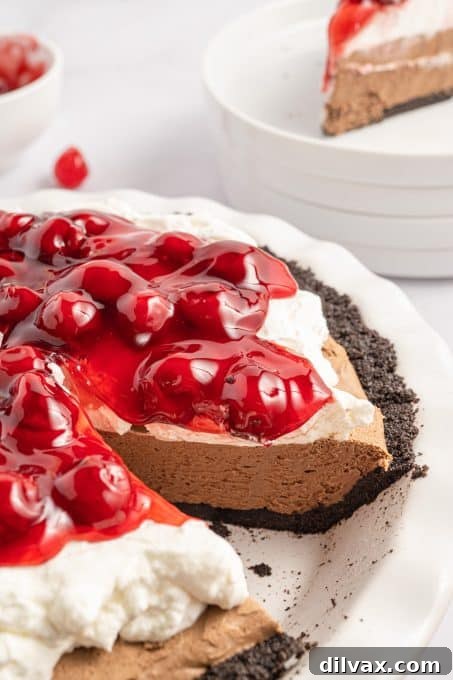 Decadent Cherry Chocolate Torte 7 A no bake chocolate pie with whipped topping and cherry pie filling, garnished.