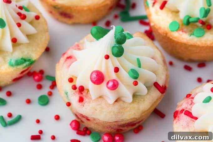 Yuletide Cookie Delights 2 Delicious Christmas Cookie Cups adorned with festive sprinkles and creamy frosting, perfect for holiday gatherings.