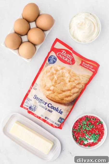 Yuletide Cookie Cups 4 Ingredients laid out for making Christmas Cookie Cups, including cookie mix, butter, egg, sprinkles, and frosting