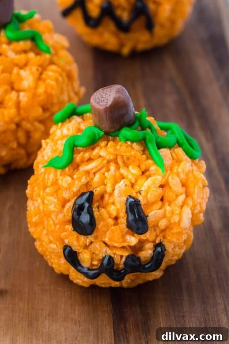 A single pumpkin treat made out of rice cereal, beautifully decorated