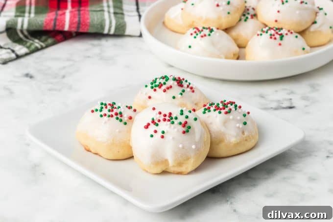 Pillowy Ricotta Delights 2 Delicious Ricotta Cookies, freshly baked and glazed with sprinkles, perfect for Christmas.