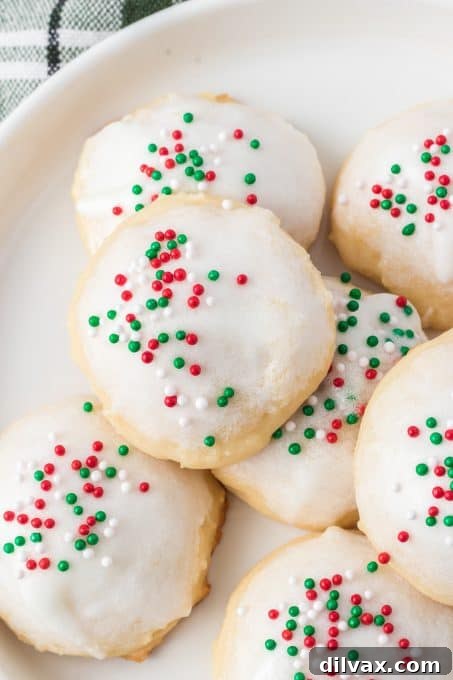 Pillowy Ricotta Delights 3 Close-up of freshly baked Italian Ricotta Cookies with a vibrant glaze and colorful sprinkles.