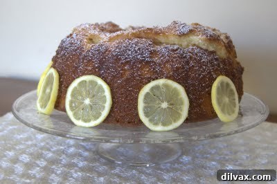 The glazed Lemon Vanilla Pound Cake absorbing the lemon syrup, making it extra moist and flavorful.