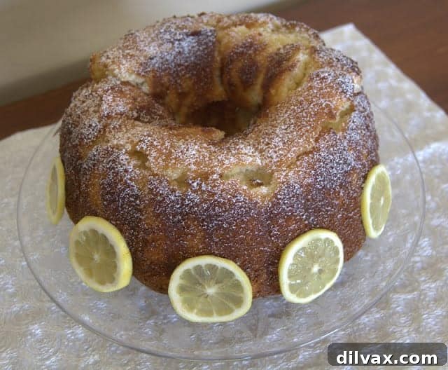 A beautifully presented slice of Lemon Vanilla Pound Cake, showcasing its tender crumb.