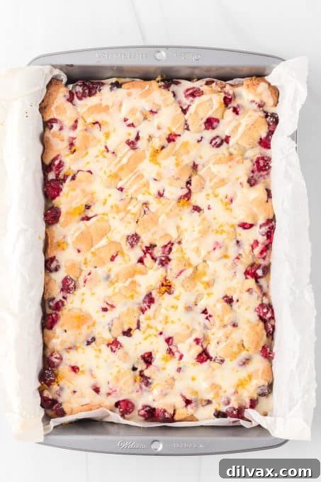 Freshly baked pie bars with cranberries and a citrus glaze.