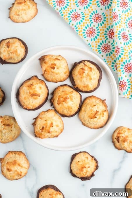 Chewy Coconut Delights 9 Close-up of a stack of chocolate-dipped coconut cookies, ready to be enjoyed