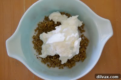 The stiff egg white mixture gently folded into the egg yolk, brown sugar, and nut base, creating a lighter, aerated batter.