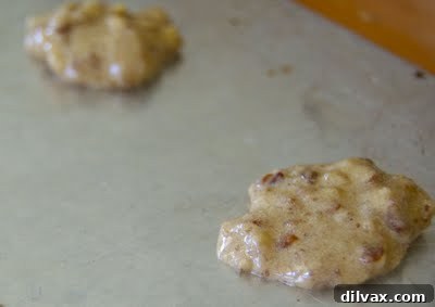 Small portions of cookie dough dropped onto an ungreased baking sheet, spaced appropriately for spreading during baking.