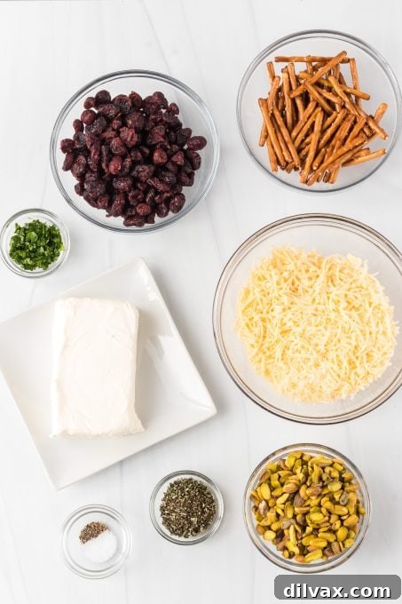 Assortment of fresh ingredients for Cranberry Cheese Balls, including cream cheese, cheddar, cranberries, and herbs.