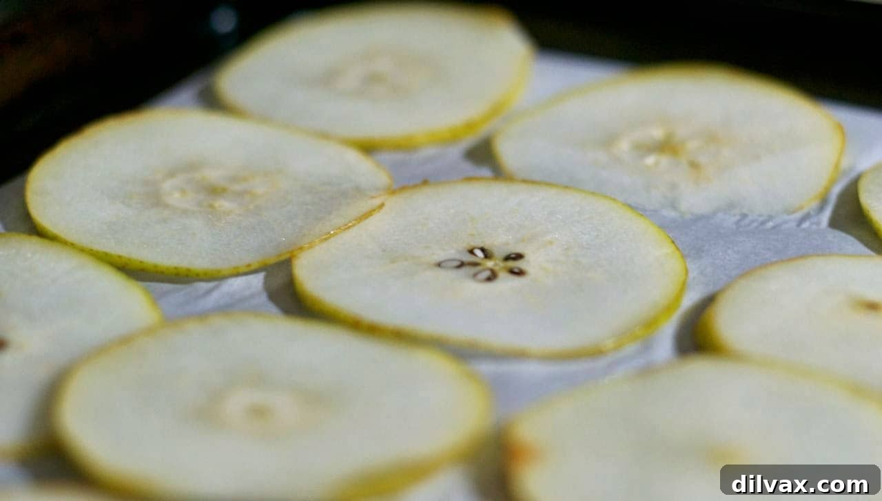 Warm Spiced Pear Delights 3 A close-up of baked pear slices arranged on a plate, ready to be served.