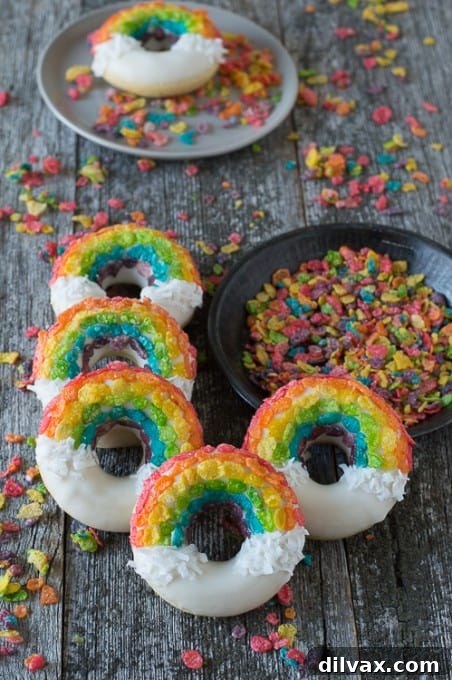 Freshly baked rainbow donuts with colorful glazes.
