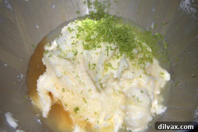 Mixing wet ingredients for lime coconut cookies: butter, sugar, egg, vanilla, lime zest, and juice.