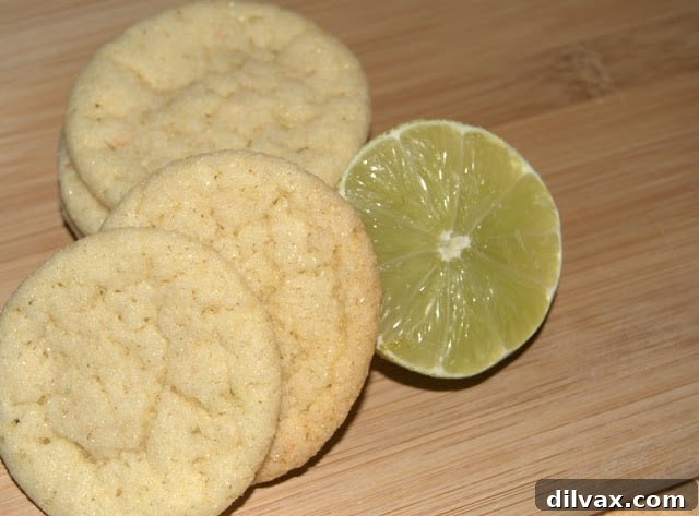 A stack of perfectly baked Chewy Lime Coconut Sugar Cookies on a white plate.