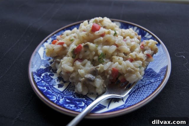 Unscheduled Treat For You 2 Creamy Sausage, Red Pepper, and Mushroom Risotto served in a bowl, garnished with fresh herbs.