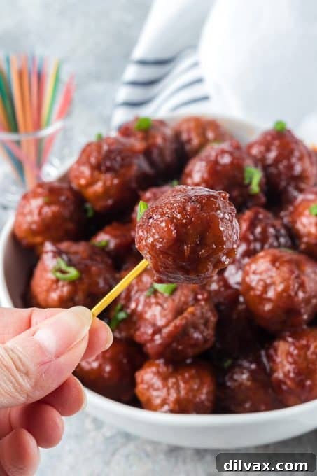 A platter of delicious Cranberry Meatballs, glistening with a tangy and sweet sauce, perfect for holiday or party appetizers.