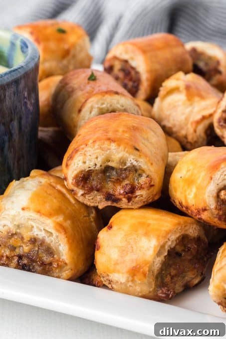 Touchdown Treats: 33 Effortless Game Day Recipes 31 Golden brown Sausage Rolls, perfect for a party appetizer.