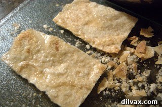 Baked cinnamon sugar tortilla rectangles on a cooling rack