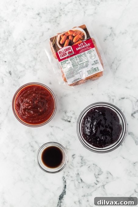 Smoked sausages, chili sauce, grape jam, and Worcestershire sauce laid out for cooking.