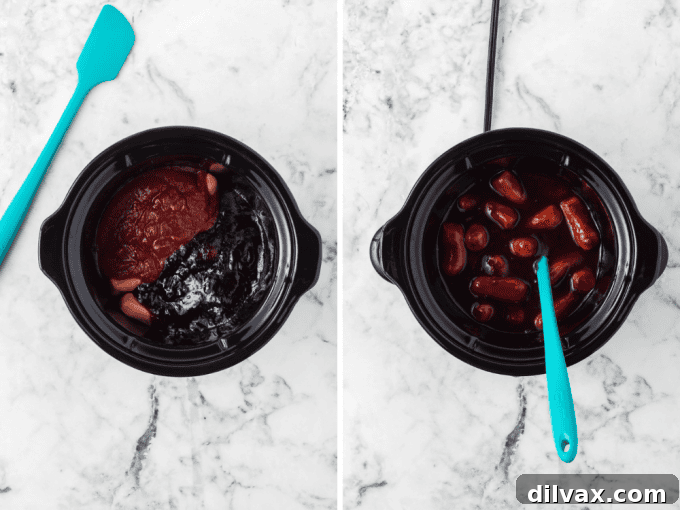 Grape jelly, chili sauce, and cocktail sausages being combined in a slow cooker with a spatula.