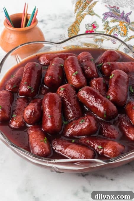 Crockpot Lil Smokies served in a bowl with toothpicks and a napkin for easy snacking.