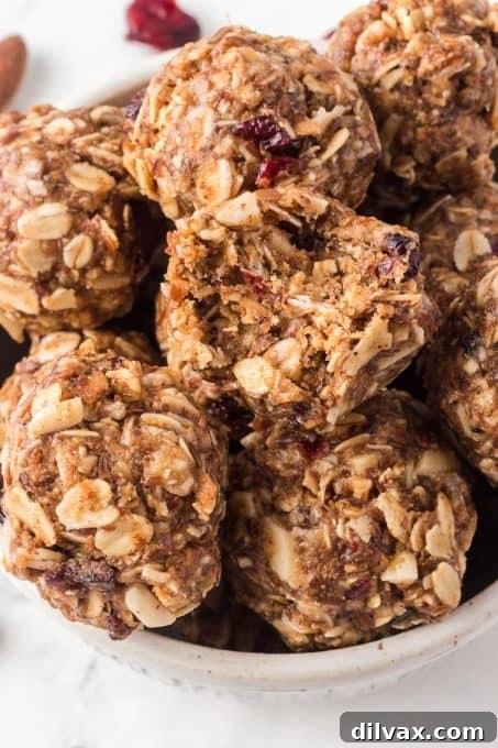 Wholesome Power Pops 10 A No-Bake Energy Bite with a bite taken out, showing the delicious interior.